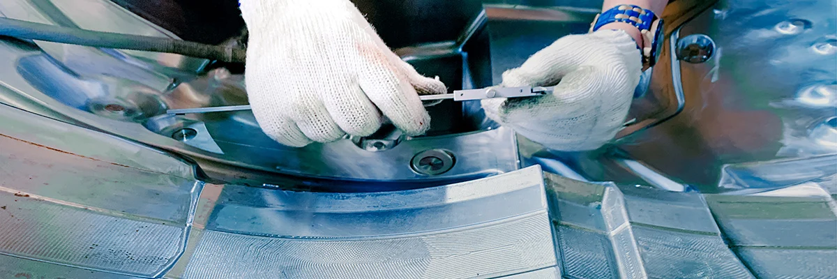 Worker repairing plastic moldign machine